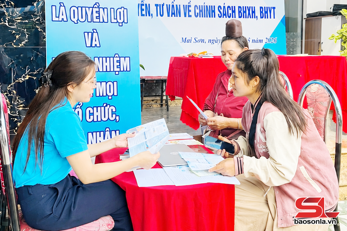 Viên chức BHXH cơ sở Mai Sơn tuyên truyền chính sách BHXH, BHYT cho nhân dân.