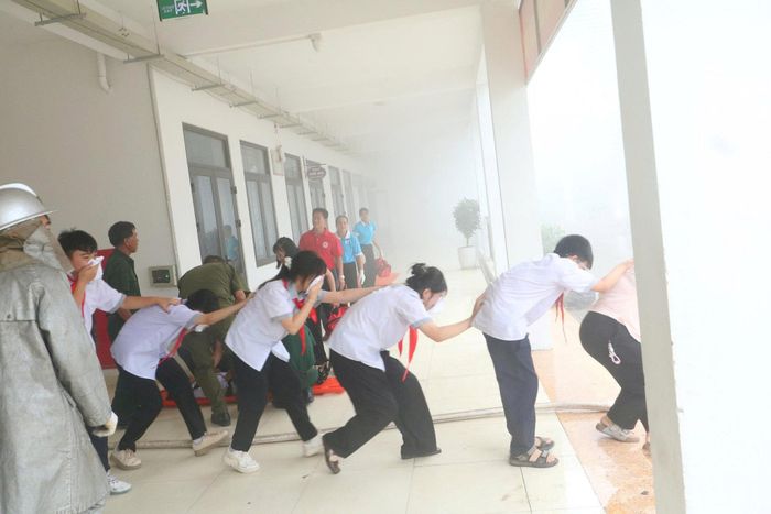 Tình huống giả định, hướng dẫn các em học sinh thoát khỏi đám cháy. Ảnh: Dung Vũ