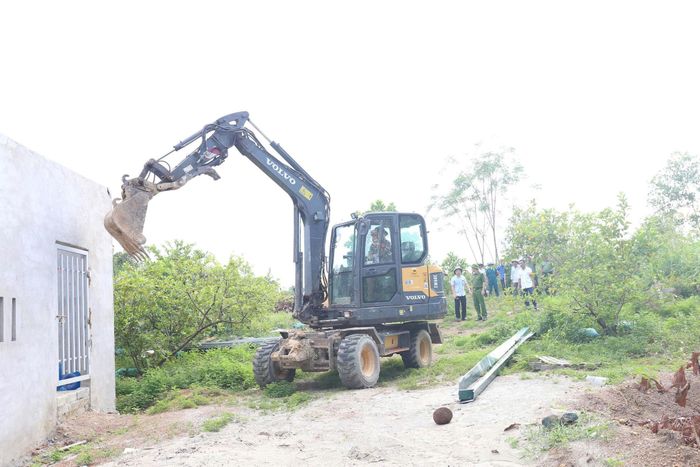 Lực lượng chức năng xã Bất Bạt phối hợp cùng người dân tháo dỡ công trình vi phạm.