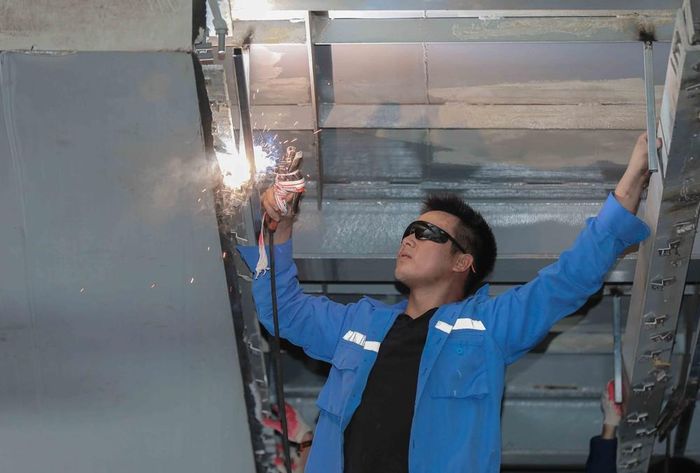 Công nhân đang khẩn trương gia cố, lắp đặt các thanh sắt kiên cố tại khu vực nhà ga Láng