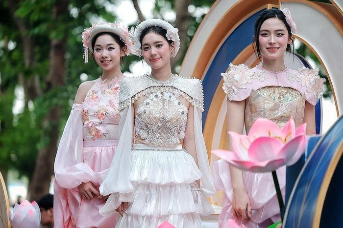 Các người mẫu trong trang phục lấy cảm hứng từ hoa sen trình diễn trên xe hoa