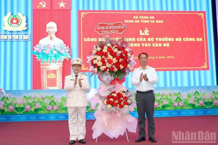 Đồng chí Lữ Quang Ngời, Phó Bí thư Tỉnh ủy, Chủ tịch Ủy ban nhân dân tỉnh Cà Mau (bên phải), tặng hoa chúc mừng Đại tá Lê Mạnh Hùng đến nhận nhiệm vụ tại Công an tỉnh Cà Mau.