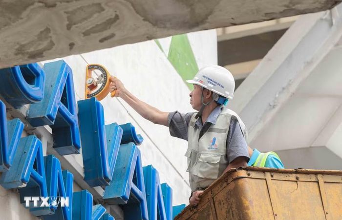 Các kỹ sư sử dụng búa bật nảy chuyên dụng để kiểm tra, đánh giá chính xác cường độ và chất lượng lớp vữa trát tại các nhà ga. (Ảnh: Phan Phương/TTXVN)