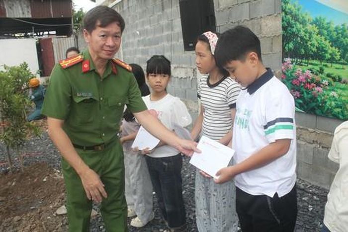 Thượng tá Hồ Hoàng Thanh, Trưởng Công an phường Dĩ An tặng quà cho các em nhỏ