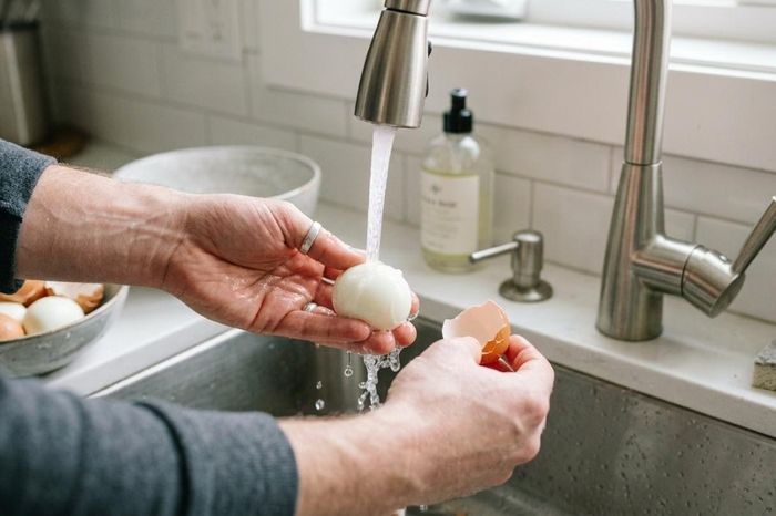 Bóc trứng luộc dưới vòi nước giúp trứng luộc giữ được vẻ hoàn hảo. (Ảnh: WH)