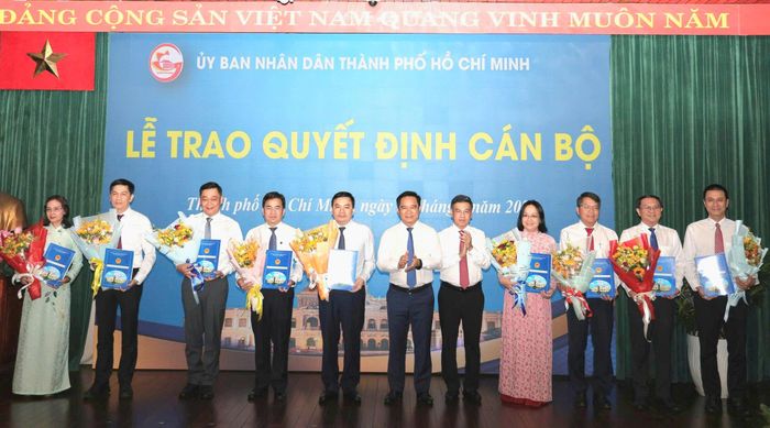  Chủ tịch UBND TPHCM Nguyễn Văn Được, Phó Chủ tịch HĐND TPHCM Nguyễn Văn Dũng trao quyết định và tặng hoa đến cán bộ. Ảnh: NGÔ BÌNH 