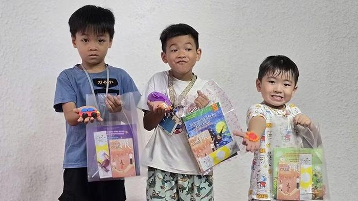 Tặng sách cho các em thiếu nhi tại Chung cư Xi Grand Court. (Ảnh: Nhà xuất bản Tổng hợp)