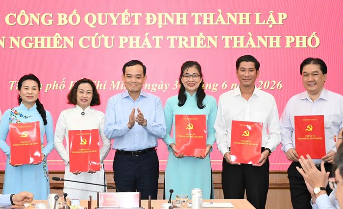  Đồng chí Trần Lưu Quang trao quyết định cho các thành viên Ban Nghiên cứu phát triển TPHCM. Ảnh: VIỆT DŨNG 