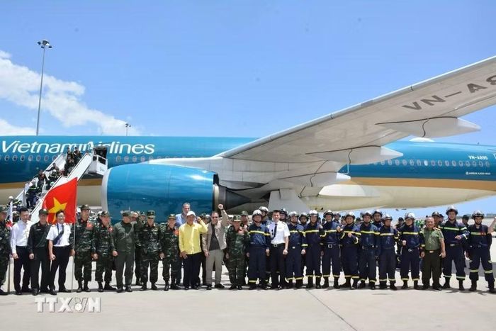 Đại biểu Việt Nam và Venezuela cùng tổ bay Vietnam Airlines chụp ảnh chung với đoàn tại sân bay quốc tế Simon Bolivar ở thành phố Maiquetia, bang La Guaira. (Ảnh: Hoàng Vũ/TTXVN phát)
