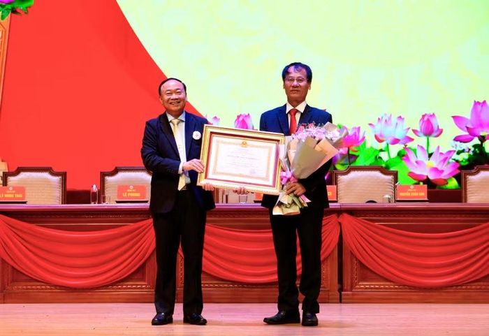  Thừa ủy quyền của Chủ tịch nước, Bí thư Tỉnh ủy Thái Đại Ngọc (trái) tặng Huân chương Lao động hạng nhì cho ông Dương Đình Diện. Ảnh: Nguyễn Muội 