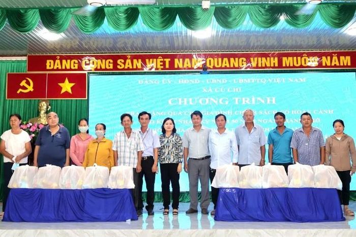 Lãnh đạo xã Củ Chi cùng đại diện các gia đình chính sách chụp ảnh lưu niệm tại chương trình trao tặng quà, lan tỏa tinh thần tri ân và nghĩa tình.