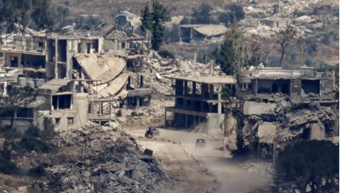  Phương tiện quân sự của Israel di chuyển giữa những tòa nhà bị phá hủy ở Lebanon. (Ảnh: Reuters)