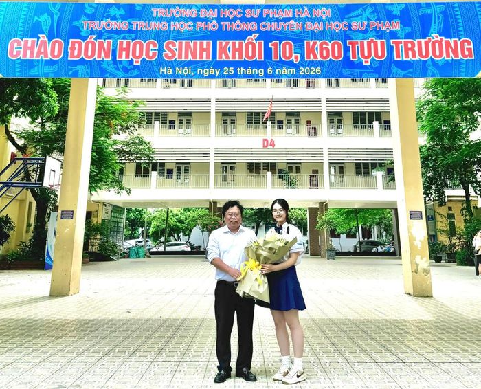Thầy Trương Trọng Khánh, giáo viên chủ nhiệm lớp 12 Toán 1 Trường THPT chuyên Sư phạm tặng hoa chúc mừng em Hoàng Hương Giang sau khi có kết quả thi tốt nghiệp THPT 2026. 