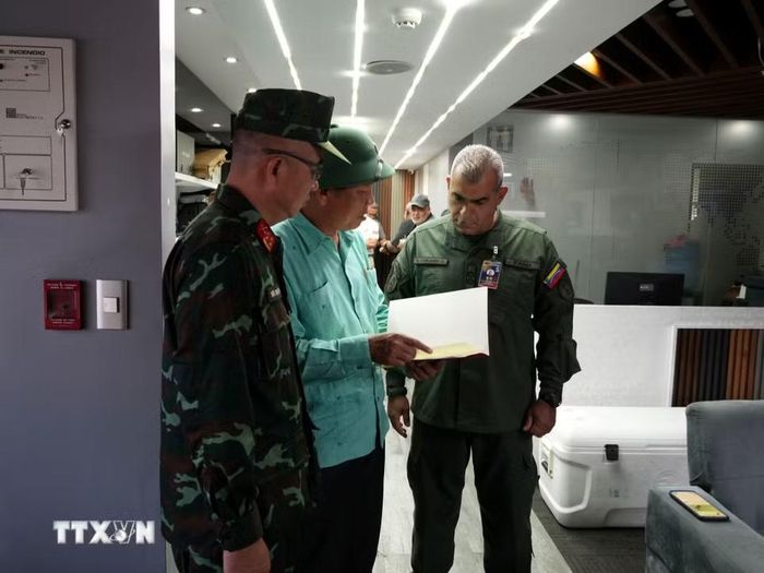 Đại sứ Việt Nam tại Venezuela trao thư của Bộ trưởng Quốc phòng Việt Nam cho đại diện lãnh đạo Bộ Quốc phòng Venezuela. (Ảnh: Phi Hùng/TTXVN)