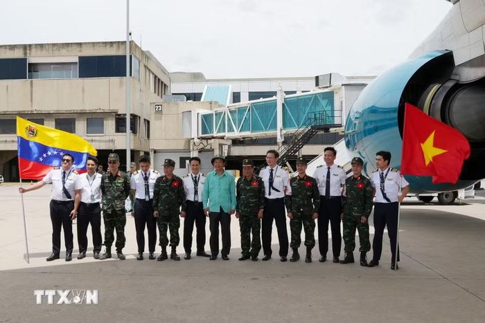 Thành viên tổ bay Vietnam Airlines chụp ảnh chung cùng đại diện Venezuela. (Ảnh: Phi Hùng/TTXVN)