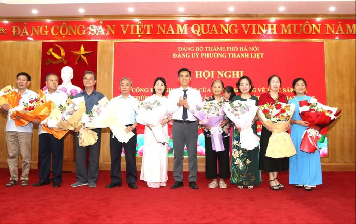 Lãnh đạo phường trao các quyết định và tặng hoa chúc mừng 15 chi bộ tổ dân phố. Ảnh: PV