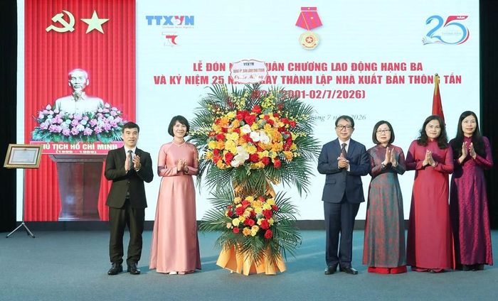 Đại diện Ban Giám đốc Thông tấn xã Việt Nam tặng hoa chúc mừng Nhà xuất bản Thông tấn