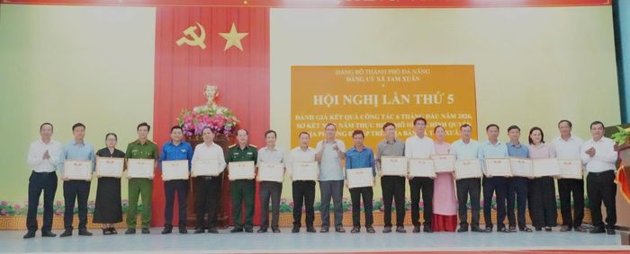 Lãnh đạo xã Tam Xuân tặng Giấy khen cho các tập thể và cá nhân. Ảnh: Ái Ly.