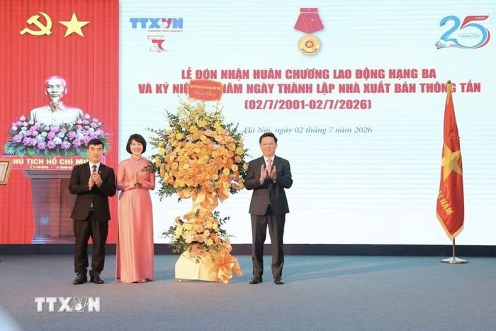 Đồng chí Trần Thanh Lâm, Ủy viên Trung ương Đảng, Phó trưởng Ban Tuyên giáo và Dân vận Trung ương thay mặt Ban Tuyên giáo và Dân vận Trung ương tặng hoa chúc mừng Nhà xuất bản Thông tấn. (Ảnh: Minh Quyết/TTXVN)