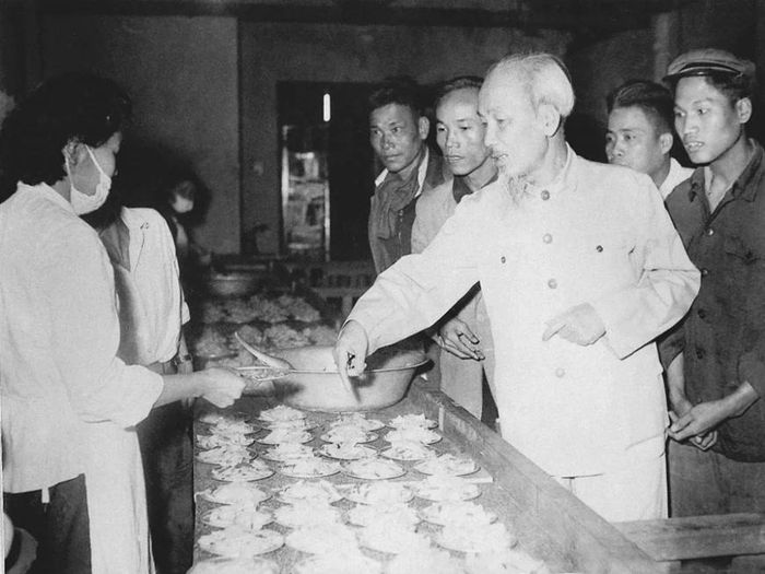Thăm các nhà máy cao su, xà phòng và thuốc lá Hà Nội, Chủ tịch Hồ Chí Minh xem suất ăn bồi dưỡng giữa ca của công nhân ngày 26/1/1961. Ảnh: hochiminh.vn