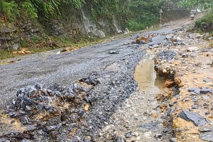 Một vị trí mặt đường, rãnh thoát nước bị đất đá và dòng chảy gây hư hỏng sau mưa lớn.
