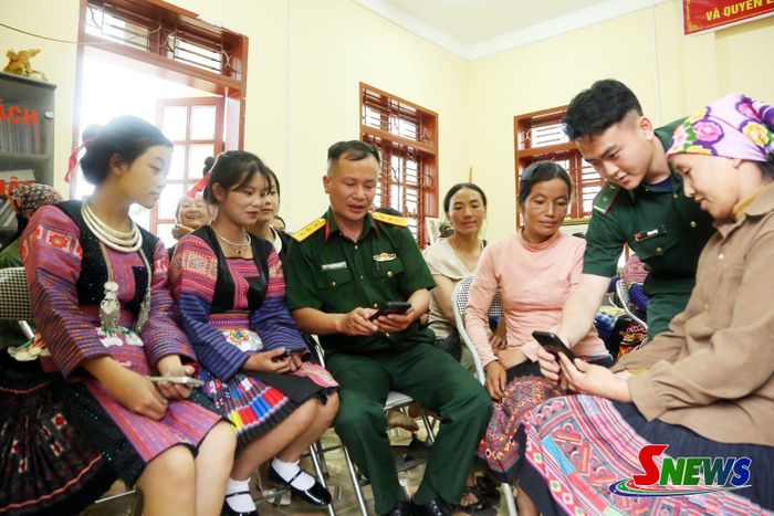 Cán bộ Đồn Biên phòng Chiềng On hướng dẫn hội viên phụ nữ sử dụng ứng dụng VNeID.