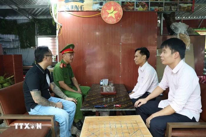 Cán bộ ngân hàng và lực lượng công an đến thăm hỏi, động viên, hướng dẫn các khách hàng (là người chấp hành xong án phạt tù) sử dụng vốn vay hiệu quả, đúng mục đích. (Ảnh Khiếu Tư/TTXVN)