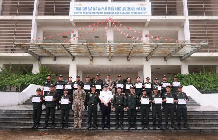 Các sĩ quan Công an Việt Nam chụp ảnh lưu niệm cùng đoàn chuyên gia tại Trung tâm Đào tạo và Phát triển năng lực gìn giữ hòa bình.