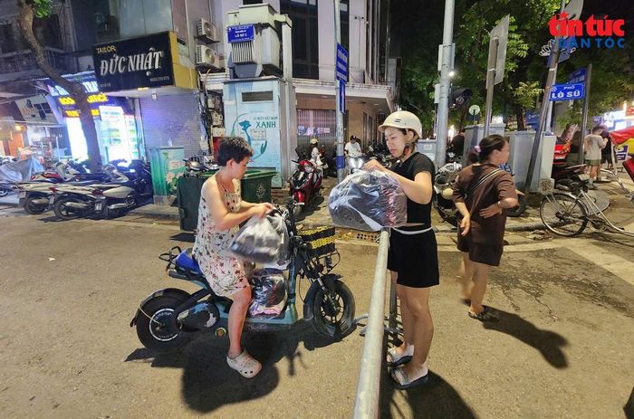 Khi xe xăng không được lưu thông trong vùng phát thải thấp, người dân trong phố cổ gọi người thân đi xe điện ra đầu phố Lò Sũ để chở đồ về nhà.