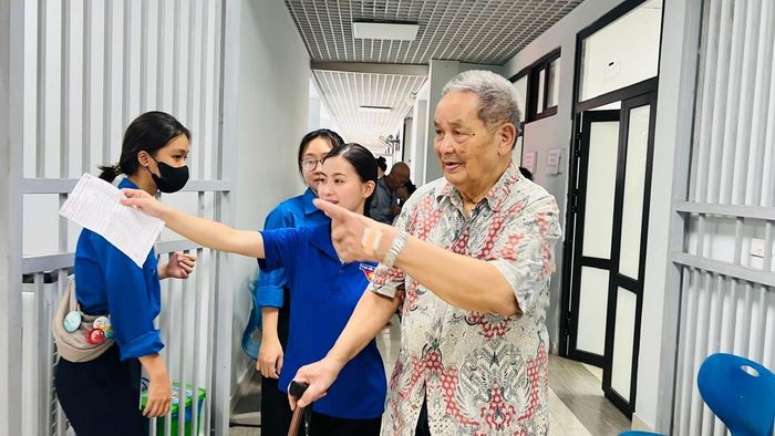 Lực lượng thanh niên tình nguyện hỗ trợ người cao tuổi trong suốt quá trình khám sức khỏe. Ảnh: Lê Hà
