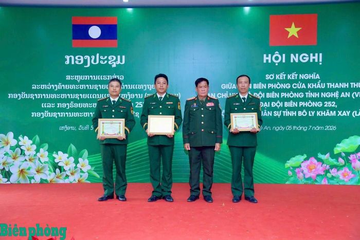 Đại tá Chăn-ni Si-súc, Chính ủy Bộ Chỉ huy Quân sự tỉnh Bô Ly Khăm Xay trao Giấy khen tặng 1 tập thể và 2 cá nhân thuộc Đồn Biên phòng cửa khẩu Thanh Thủy có thành tích xuất sắc trong thực hiện chương trình kết nghĩa. Ảnh: Lê Thạch