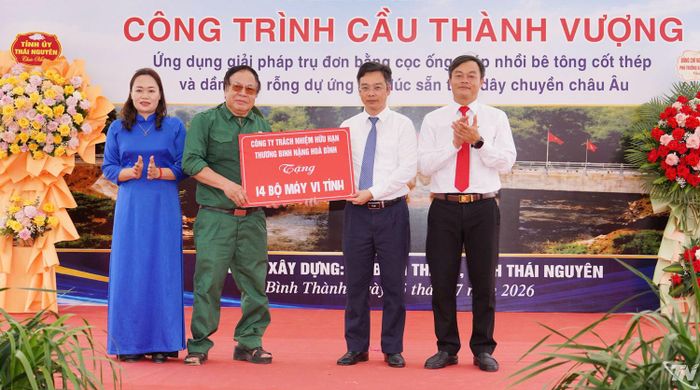 Đại diện Công ty TNHH Thương binh nặng Hòa Bình trao tặng 14 bộ máy vi tính cho xã Bình Thành.