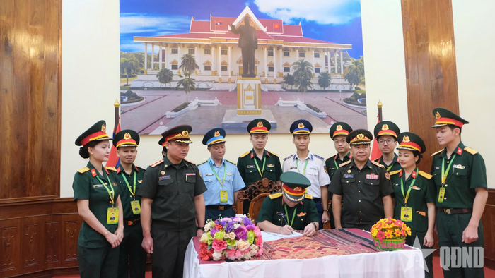 Đại úy Lê Hảo viết lưu bút tại Bảo tàng Kaysone Phomvihane. 