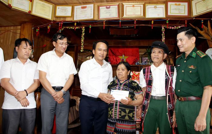 Phó Bí thư Thường trực Thành ủy Nguyễn Đình Vĩnh thăm, tặng quà gia đình bà Coor Thị Bít. Ảnh: TRỌNG HUY