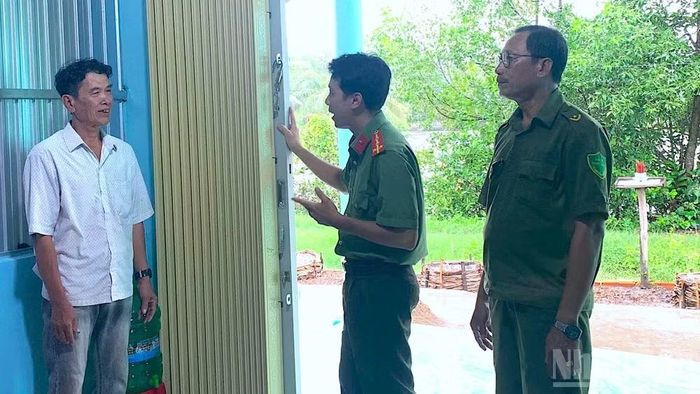 Ông Huỳnh Văn Hải (bìa trái), ngụ ấp Bình Thành, xã Cái Nước (tỉnh Cà Mau) chia sẻ niềm vui trong căn nhà mới khang trang do Bộ Công an hỗ trợ.