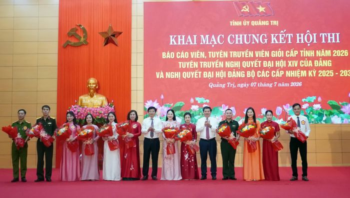 Đồng chí Trần Vũ Khiêm, Phó Bí thư Thường trực Tỉnh ủy, Trưởng đoàn đại biểu Quốc hội tỉnh và đồng chí Trương An Ninh, Trưởng ban Tuyên giáo và Dân vận Tỉnh ủy, Trưởng ban Tổ chức hội thi cấp tỉnh tặng hoa cho các thí sinh - Ảnh: N.M