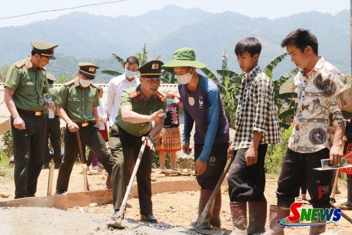 Cán bộ Phòng An ninh kinh tế tham gia đổ bê tông đường về các bản vùng cao.