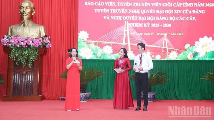 Thí sinh tham dự Hội thi báo cáo viên, tuyên truyền viên giỏi cấp tỉnh (trái) đang thực hiện phần thi trả lời câu hỏi của Ban Giám khảo.