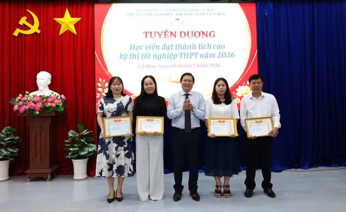 Ông Nguyễn Quốc Tuấn, Giám đốc Trung tâm GDTX Cà Mau trao giấy khen cho giáo viên.
