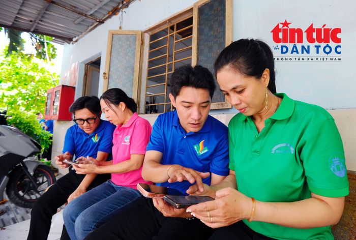 Anh Lý Hữu Hoàng Giang (thứ hai từ phải qua), Phó Bí thư Đoàn phường Bình Thạnh hướng dẫn người dân ở khu phố cài đặt app "Công dân số TP Hồ Chí Minh".