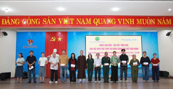 Lãnh đạo Hội Cựu Thanh niên xung phong thành phố Đà Nẵng (thứ 8, từ phải qua) và đại diện chùa Linh Ứng - Bãi Bụt (thứ 7, từ trái qua) trao quà cho hội viên cựu Thanh niên xung phong có hoàn cảnh đặc biệt khó khăn. Ảnh: ĐẮC MẠNH