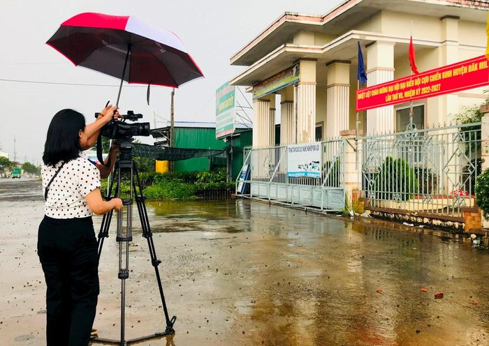 Để hoàn thành nhiệm vụ, phóng viên sẵn sàng chịu ướt để bảo vệ thiết bị, máy móc
