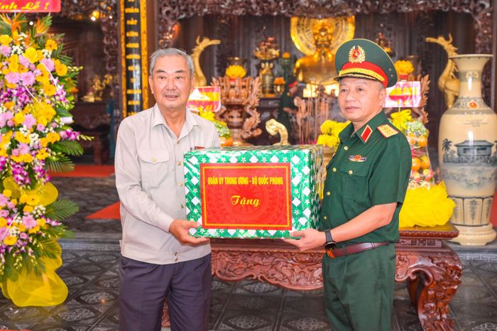 Thượng tướng Lê Quang Minh, Phó Chủ nhiệm Tổng cục Chính trị Quân đội nhân dân Việt Nam trao tặng quà cho đại diện ban quản lý Đền tưởng niệm Anh hùng liệt sĩ và Người có công tỉnh An Giang. Ảnh: Phương Vũ