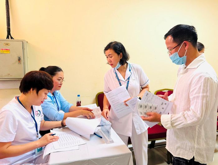 Người dân đến khám được đội ngũ bác sỹ tiếp đón và hướng dấn quy trình khám. Ảnh: Nguyên Bảo