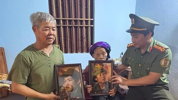 Đại diện đoàn công tác trao ảnh liệt sĩ phục dựng cho gia đình Bà mẹ Việt Nam Anh hùng.