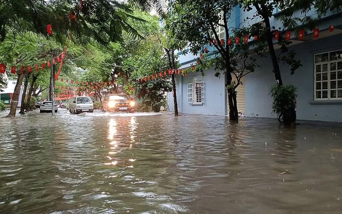 Tại phố Hoàng Ngọc Phách - Ngô Kim Tài (phường Lê Chân) ngập khoảng 20-25cm. Nước mưa thoát chậm tràn lên vỉa hè, nhà dân.