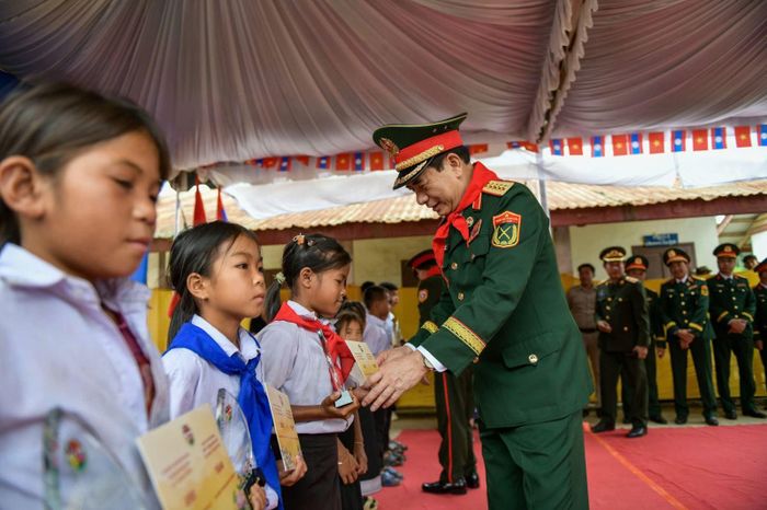 Đại tướng Phan Văn Giang - Ủy viên Bộ Chính trị, Phó Thủ tướng Chính phủ, Bộ trưởng Bộ Quốc phòng Việt Nam trao học bổng cho các em học sinh Trường Tiểu học Thông-năm-mun, bản Xốp-tờng.