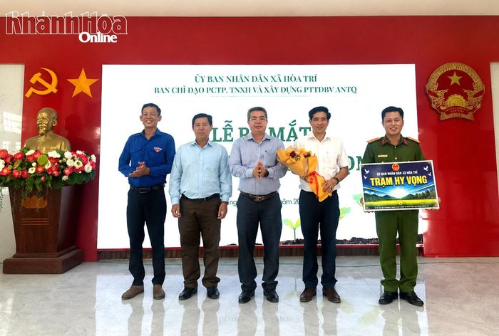 Lãnh đạo Đảng ủy xã Hòa Trí trao bảng tượng trưng thành lập mô hình "Trạm hy vọng".