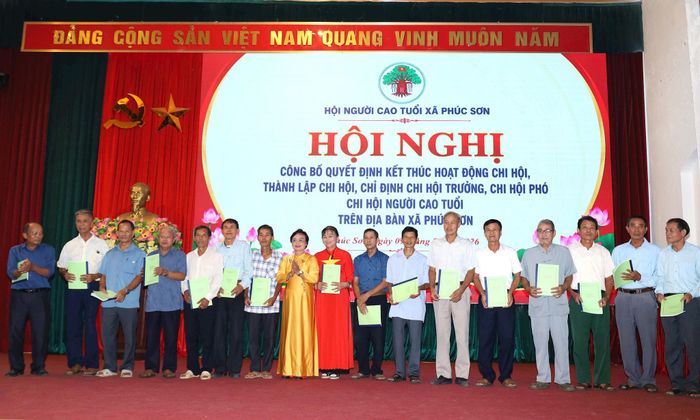 Chủ tịch Hội Người cao tuổi xã Phúc Sơn Lê Thị Thúy Nga trao quyết định chỉ định chức danh Chi hội trưởng Chi hội Người cao tuổi các thôn trên địa bàn xã. Ảnh: Kim Nhuệ