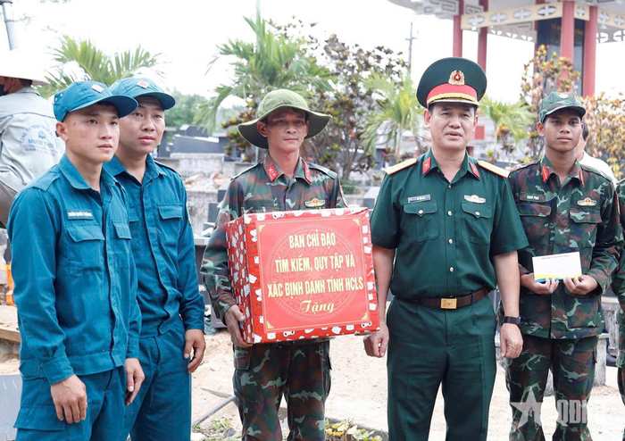  Đại tá Võ Tấn Tài trao quà tặng lực lượng thực hiện nhiệm vụ khai quật, lấy mẫu sinh phẩm hài cốt liệt sĩ tại Nghĩa trang Liệt sĩ Bình Nghi (Gia Lai). 